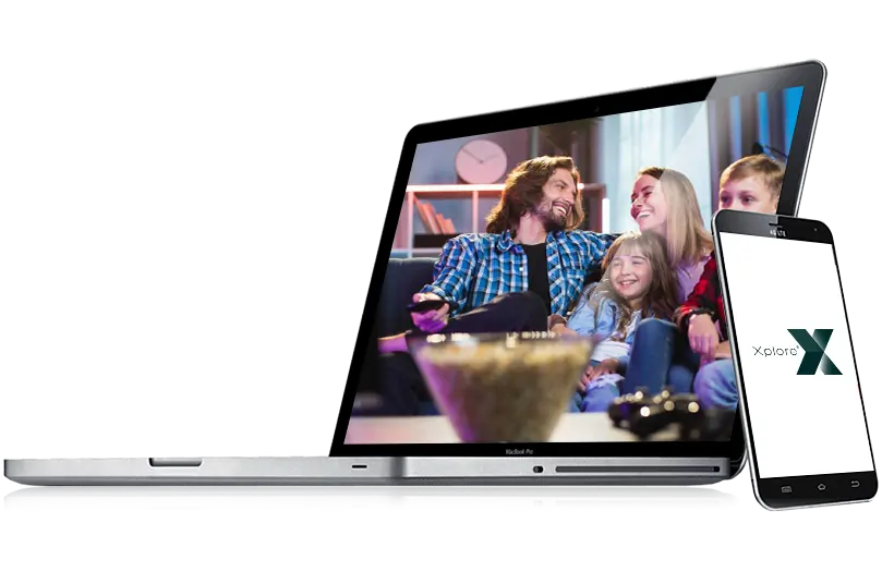 Laptop with image of family on the screen with mobile phone leaning against laptop.