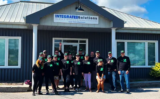 Several Integrated-Solutions workers standing outside an establishment