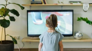 Girl watching tv in modern living room.